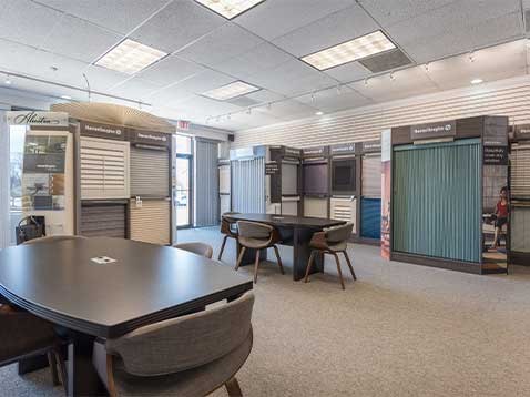 Store interior showcasing several different types of window coverings